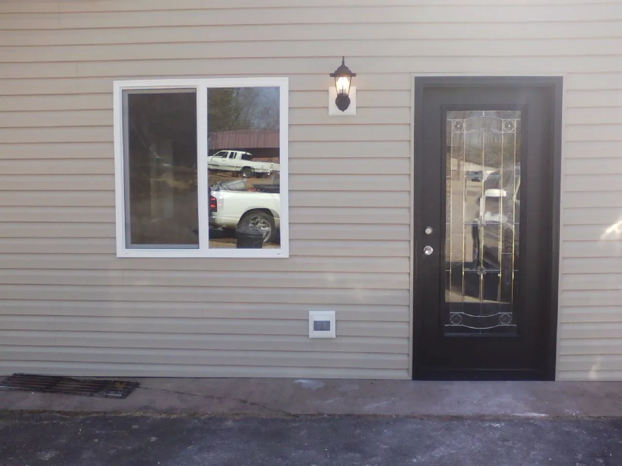 New siding, window and entry door on the side of an addition in Nicholson